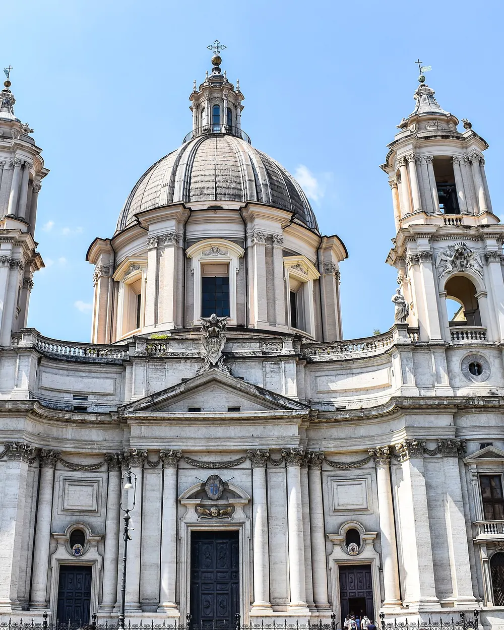 The front of Sant'Agnese in Agone, the Baroque church beside Palazzo Pamphilj, with its dome and two bell towers.
